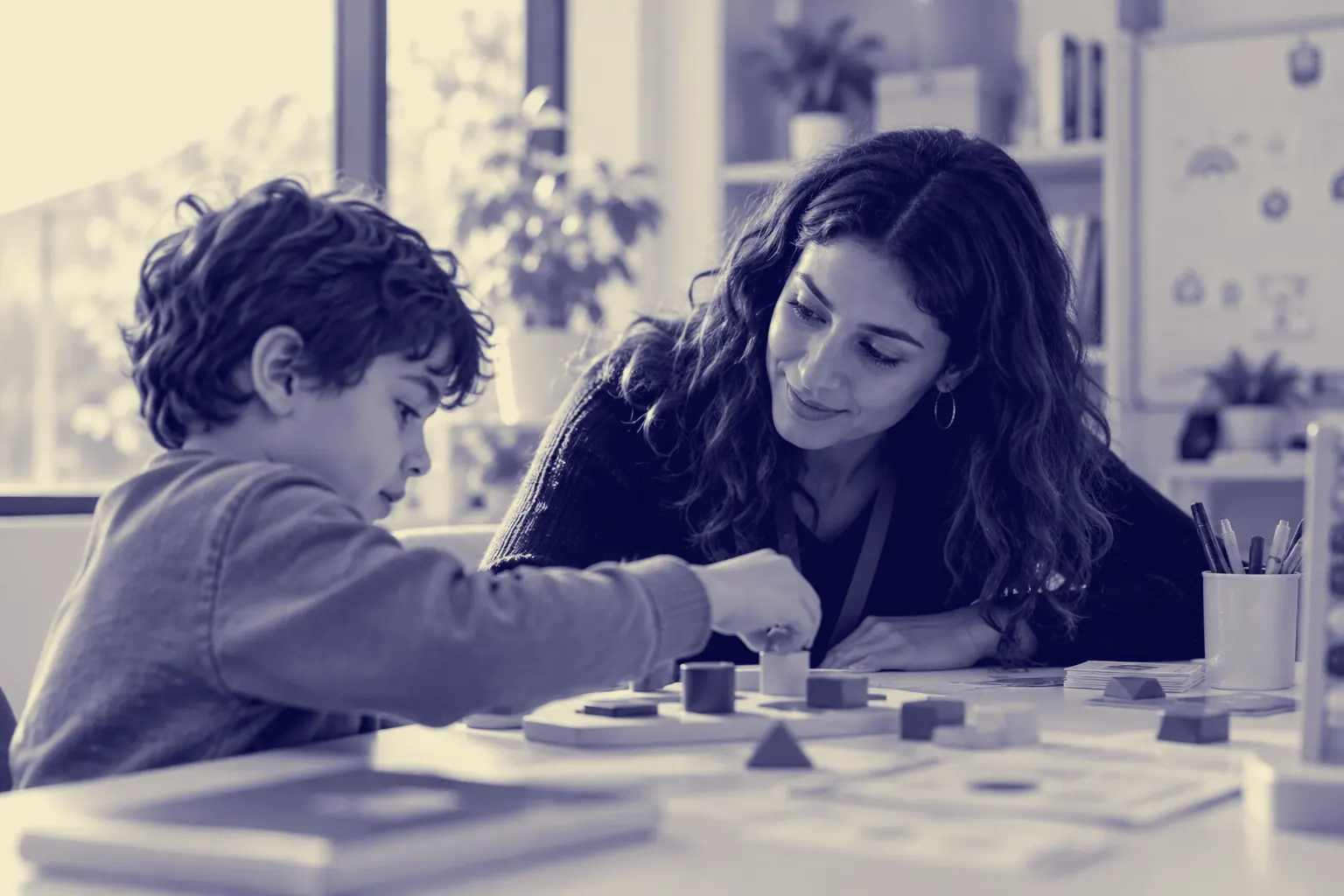 A practitioner working alongside a child at a table